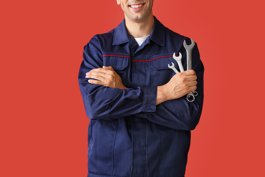 mechanic standing in front of red background